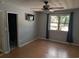Bedroom featuring wood laminate flooring, ceiling fan, and mounted TV at 302 St. Andrews Ln., Myrtle Beach, SC 29588