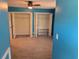 Bright bedroom featuring two large, open closets with ample storage, carpeted floor and light blue walls at 302 St. Andrews Ln., Myrtle Beach, SC 29588