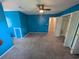 Bright bedroom with blue walls, carpeted floors, and an open closet with white doors, plus a ceiling fan at 302 St. Andrews Ln., Myrtle Beach, SC 29588