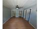 Bedroom featuring wood laminate flooring, ceiling fan, and open closet at 302 St. Andrews Ln., Myrtle Beach, SC 29588