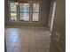 Bright dining area with white tile flooring and a view of the screened-in porch at 302 St. Andrews Ln., Myrtle Beach, SC 29588