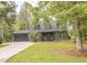 Inviting home with beautiful yard, a garage, and mature trees enhance curb appeal at 302 St. Andrews Ln., Myrtle Beach, SC 29588