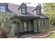 Charming curb appeal with lush greenery, dark-green painted siding and cozy front porch at 302 St. Andrews Ln., Myrtle Beach, SC 29588