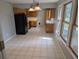Bright and airy kitchen with white tile floors, oak cabinets, and black appliances at 302 St. Andrews Ln., Myrtle Beach, SC 29588