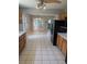 Kitchen featuring a large black refrigerator, and white tile floors with an open dining area at 302 St. Andrews Ln., Myrtle Beach, SC 29588