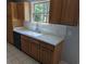 Kitchen featuring oak cabinets, white tile backsplash, and views of the wooded backyard at 302 St. Andrews Ln., Myrtle Beach, SC 29588