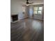 Spacious living room with hardwood floors, a fireplace, and ample natural light from the windows at 302 St. Andrews Ln., Myrtle Beach, SC 29588