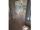 Open sunroom with lots of natural light from large windows and wood laminate flooring at 302 St. Andrews Ln., Myrtle Beach, SC 29588