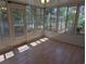 Sunroom with wood floors, lots of windows, and a door to the yard at 302 St. Andrews Ln., Myrtle Beach, SC 29588