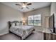 Comfortable bedroom with neutral tones, a ceiling fan, a window view, and wood furnishings at 3034 Viceroy Loop, Little River, SC 29566