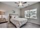 Cozy bedroom features a ceiling fan, natural light, and neutral decor at 3034 Viceroy Loop, Little River, SC 29566