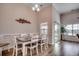 Spacious dining room with wood floors, a large window, and access to a sliding glass door at 3034 Viceroy Loop, Little River, SC 29566