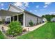 The backyard of this home offers lush grass, landscaping, a covered patio, and a serene view at 3034 Viceroy Loop, Little River, SC 29566