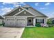 Charming single Gathering home with a three-car garage and manicured lawn at 3034 Viceroy Loop, Little River, SC 29566