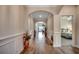 Long hallway with decorative archways and hardwood flooring at 3034 Viceroy Loop, Little River, SC 29566
