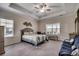 Main bedroom with a tray ceiling, a ceiling fan, and multiple windows offering plenty of light at 3034 Viceroy Loop, Little River, SC 29566