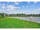 Beautiful pond view of the community featuring lush green grass and waterfront homes at 3034 Viceroy Loop, Little River, SC 29566