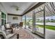 Inviting screened porch with seating area offering peaceful water views and awnings for sun protection at 3034 Viceroy Loop, Little River, SC 29566