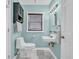 Charming powder room features a wall-mounted sink, a light fixture, and serene light blue walls at 308 44Th Ave. N, North Myrtle Beach, SC 29582