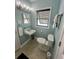 Cozy powder blue bathroom with a pedestal sink and toilet with black fixtures at 308 44Th Ave. N, North Myrtle Beach, SC 29582