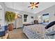 Bright bedroom with two beds, a ceiling fan, dresser with TV, and a seating bench at 308 44Th Ave. N, North Myrtle Beach, SC 29582