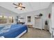 Bright bedroom with a blue-covered bed, a TV on a dresser, and a seating bench at 308 44Th Ave. N, North Myrtle Beach, SC 29582