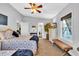 Bright bedroom featuring a bed, dresser with TV, vanity, and ceiling fan at 308 44Th Ave. N, North Myrtle Beach, SC 29582