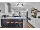 Bright kitchen features shaker cabinets, stainless appliances, wood floors and an island with seating at 308 44Th Ave. N, North Myrtle Beach, SC 29582