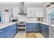 This kitchen features sleek stainless appliances, including a double oven, and stylish blue cabinets at 308 44Th Ave. N, North Myrtle Beach, SC 29582