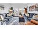 Bright living room decorated with coastal accents and featuring comfortable seating and doors to porch at 308 44Th Ave. N, North Myrtle Beach, SC 29582