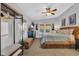 Bright main bedroom featuring a ceiling fan, natural light, television, and stylish coastal decor at 308 44Th Ave. N, North Myrtle Beach, SC 29582