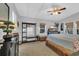 Spacious main bedroom features a ceiling fan, natural light, a TV, and a cozy coastal style at 308 44Th Ave. N, North Myrtle Beach, SC 29582