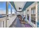 Inviting screened-in porch featuring comfortable seating, ceiling fan, and scenic views at 308 44Th Ave. N, North Myrtle Beach, SC 29582
