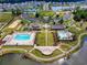 Aerial view of community with pools, clubhouse, common areas, playgrounds, and waterways at 3212 Saddlewood Circle, Myrtle Beach, SC 29579