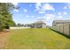 Expansive grassy backyard, perfect for outdoor activities and entertaining with rear exterior view of the house at 3212 Saddlewood Circle, Myrtle Beach, SC 29579