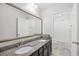 Bathroom features a granite countertop, double sinks, and a large mirror for an enhanced look at 3212 Saddlewood Circle, Myrtle Beach, SC 29579