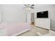 Bedroom with ceiling fan, carpeting and a TV on top of a white six-drawer dresser at 3212 Saddlewood Circle, Myrtle Beach, SC 29579