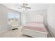 Neutral bedroom features a ceiling fan, a comfortable chair and natural light through the window at 3212 Saddlewood Circle, Myrtle Beach, SC 29579