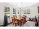 Bright dining room features hardwood floors, a modern chandelier, and natural light from several windows at 3212 Saddlewood Circle, Myrtle Beach, SC 29579