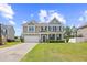 Charming two-story home boasts a well-manicured lawn, inviting entrance, and attached two car garage at 3212 Saddlewood Circle, Myrtle Beach, SC 29579