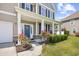 Inviting front porch decorated with red flowers, leading to a blue front door with wreath and columns at 3212 Saddlewood Circle, Myrtle Beach, SC 29579