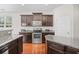 Modern kitchen features dark cabinets, stainless steel appliances, and granite countertops for cooking at 3212 Saddlewood Circle, Myrtle Beach, SC 29579