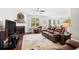 Comfortable living room with a fireplace, plush leather furniture, and lots of natural light at 3212 Saddlewood Circle, Myrtle Beach, SC 29579