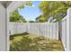 Backyard area featuring a white picket fence, grassy lawn, and shade from mature trees at 3563 Chestnut Dr. # 3563, Myrtle Beach, SC 29577