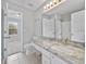 Bathroom featuring large vanity with a marble countertop, an oversized mirror, and bright lighting at 3563 Chestnut Dr. # 3563, Myrtle Beach, SC 29577