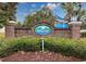 Welcoming Windsor Gate community entrance with brick sign and lush landscaping under a bright blue sky at 3563 Chestnut Dr. # 3563, Myrtle Beach, SC 29577