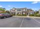 Townhome exterior showing parking, landscaping, and classic design with brick accents at 3563 Chestnut Dr. # 3563, Myrtle Beach, SC 29577