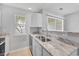 Bright kitchen with granite counters, stainless steel sink, and white cabinets at 3563 Chestnut Dr. # 3563, Myrtle Beach, SC 29577