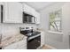 This kitchen features stainless appliances, white cabinets, and granite countertops at 3563 Chestnut Dr. # 3563, Myrtle Beach, SC 29577
