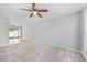 Open living room with neutral walls, ceiling fan, and access to an outdoor patio at 3563 Chestnut Dr. # 3563, Myrtle Beach, SC 29577